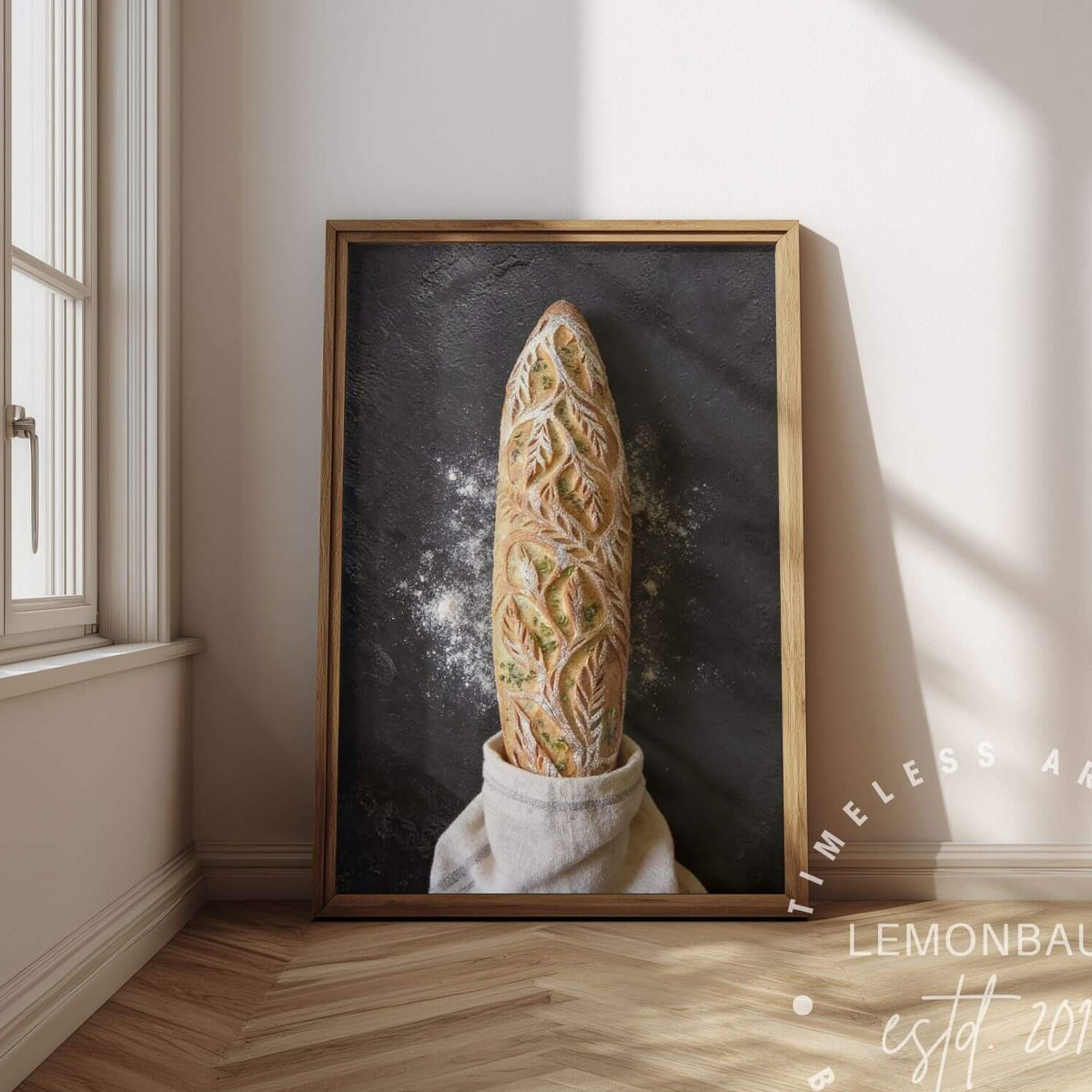 A framed vertical art print poster. The artwork shows a loaf of bread rising from a white cloth against a dark chalkboard-like background.